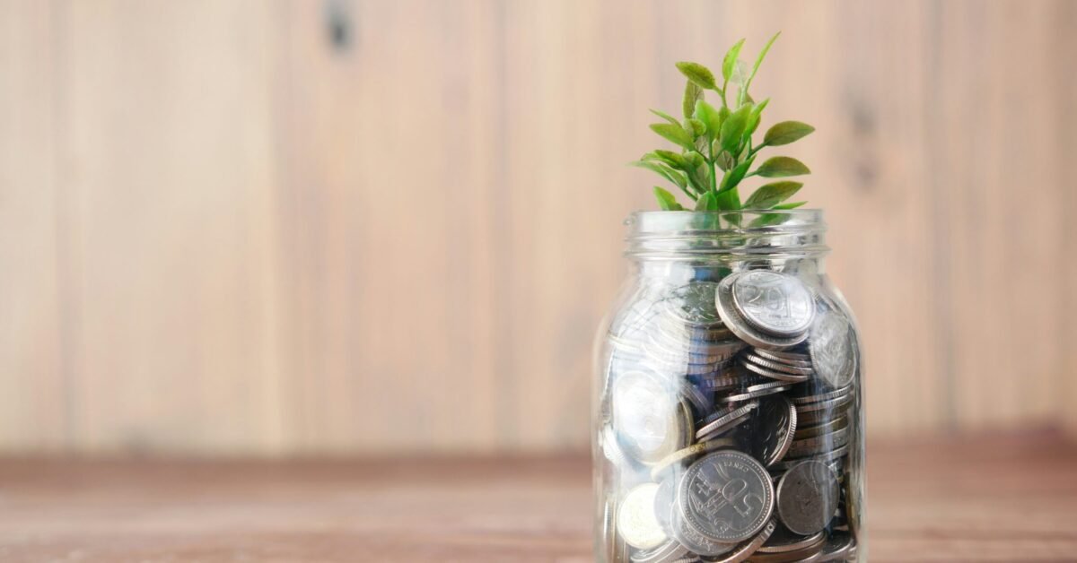 a glass jar filled with coins and a plant